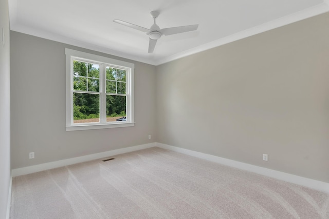 unfurnished room featuring light carpet, crown molding, visible vents, and baseboards