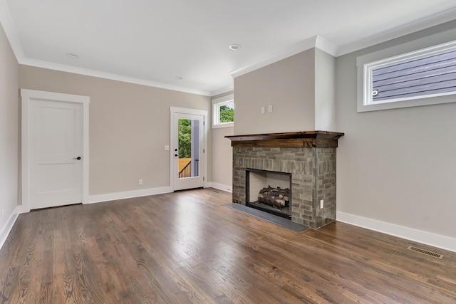 unfurnished living room with baseboards, dark wood-style flooring, visible vents, and crown molding