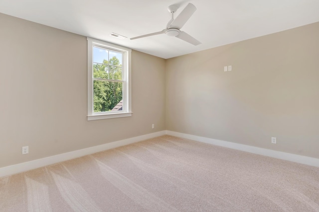 unfurnished room featuring a ceiling fan, carpet flooring, visible vents, and baseboards