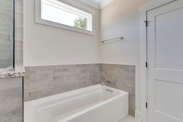 bathroom with tile walls and a bath