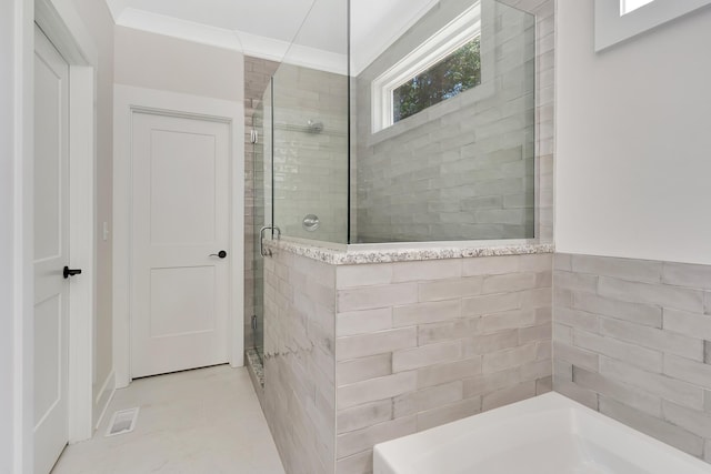 bathroom with a shower stall, visible vents, a bath, and ornamental molding