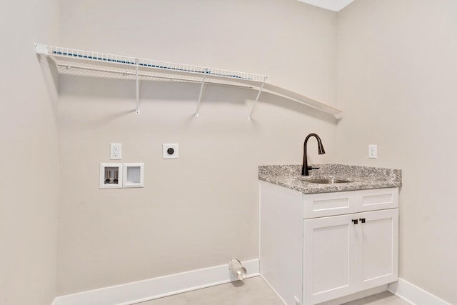 clothes washing area featuring washer hookup, baseboards, electric dryer hookup, and a sink