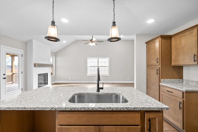 kitchen featuring a wealth of natural light, sink, ceiling fan, and lofted ceiling