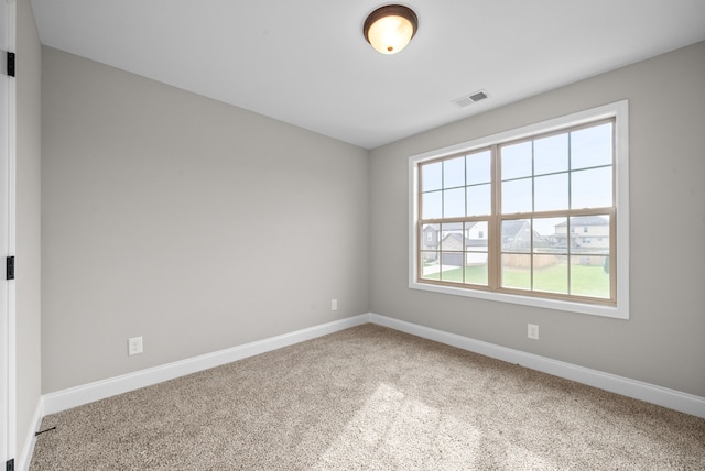 spare room with carpet and plenty of natural light