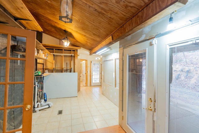 basement with light tile patterned floors, a healthy amount of sunlight, and wooden ceiling