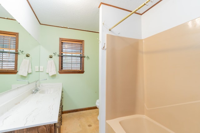 full bathroom with vanity, toilet, a healthy amount of sunlight, and a textured ceiling