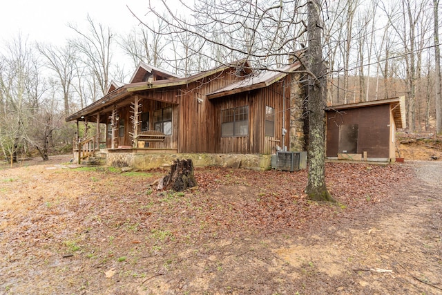 view of property exterior featuring central air condition unit and a porch