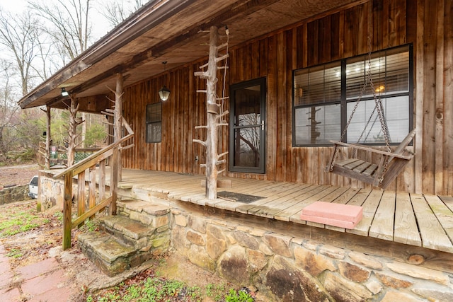 wooden terrace featuring covered porch