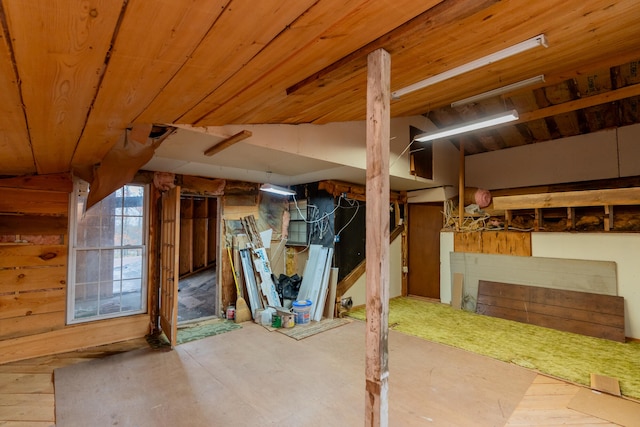 basement with wood ceiling and wood walls