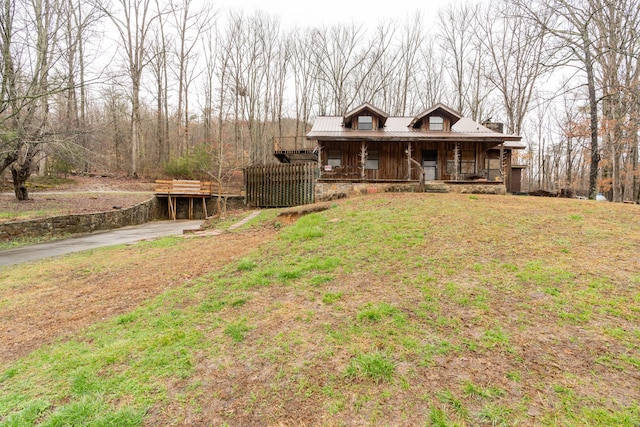 view of front of house with covered porch and a front yard