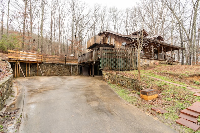 view of side of home with a deck and a carport