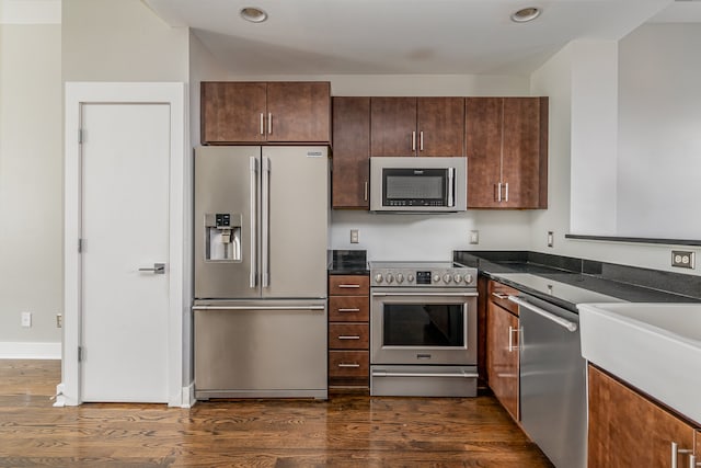 kitchen with dark hardwood / wood-style floors, dark brown cabinetry, and stainless steel appliances