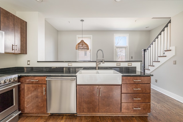 kitchen with stove, kitchen peninsula, stainless steel dishwasher, and dark wood-type flooring