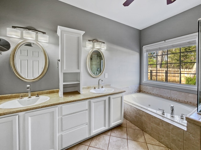 bathroom featuring tiled bath, dual bowl vanity, tile floors, and ceiling fan