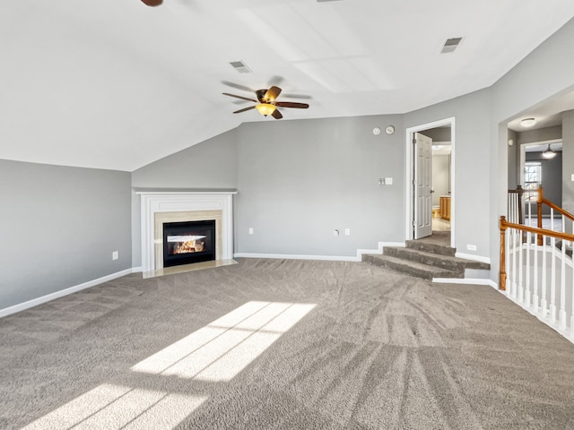 unfurnished living room featuring vaulted ceiling, ceiling fan, and carpet