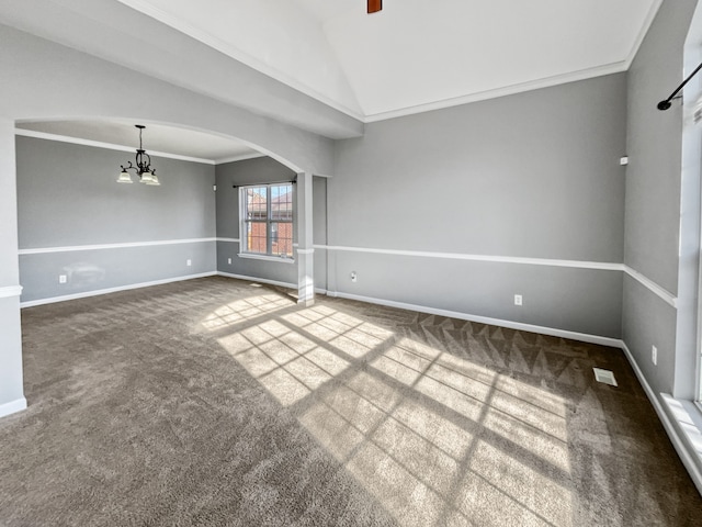 unfurnished room featuring a notable chandelier, lofted ceiling, carpet floors, and ornamental molding