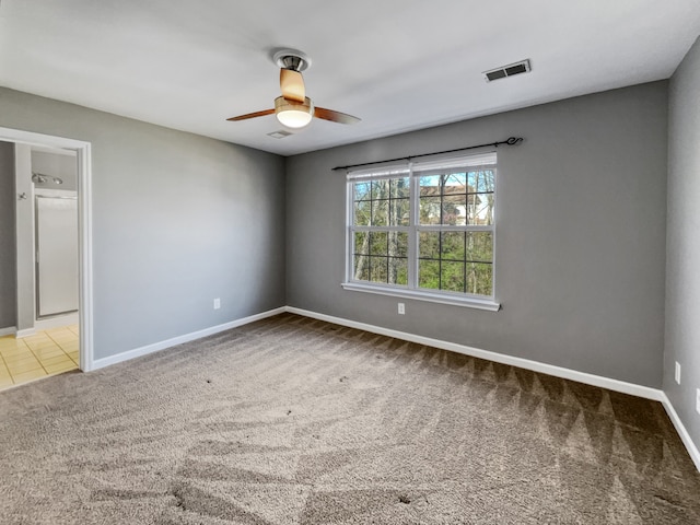 spare room with light carpet and ceiling fan