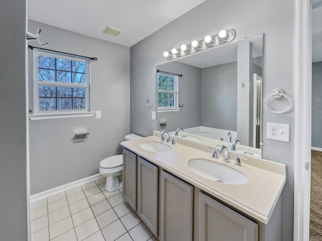 bathroom with tile flooring, double sink vanity, toilet, and a tub