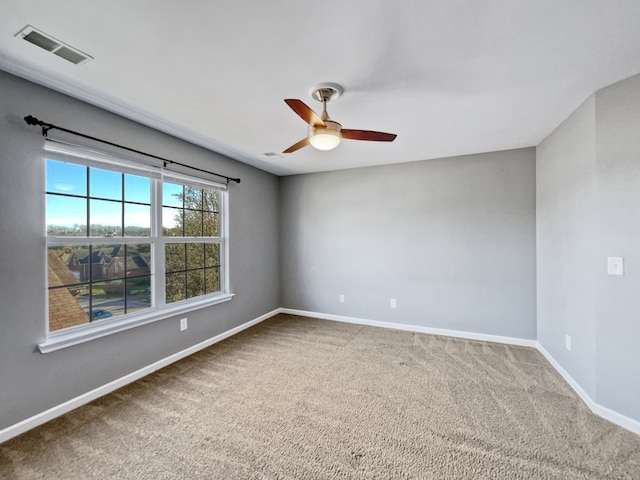 carpeted spare room featuring ceiling fan