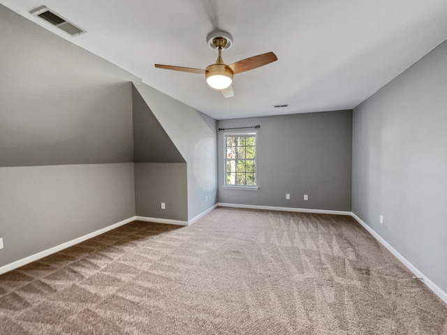 additional living space with ceiling fan, lofted ceiling, and carpet floors