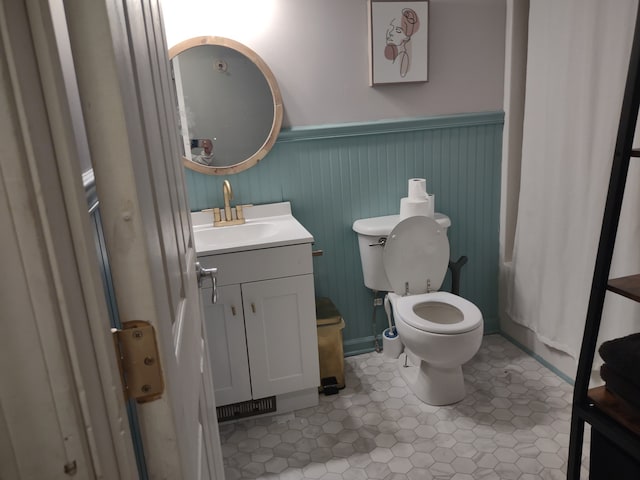 bathroom featuring vanity, toilet, and tile patterned floors