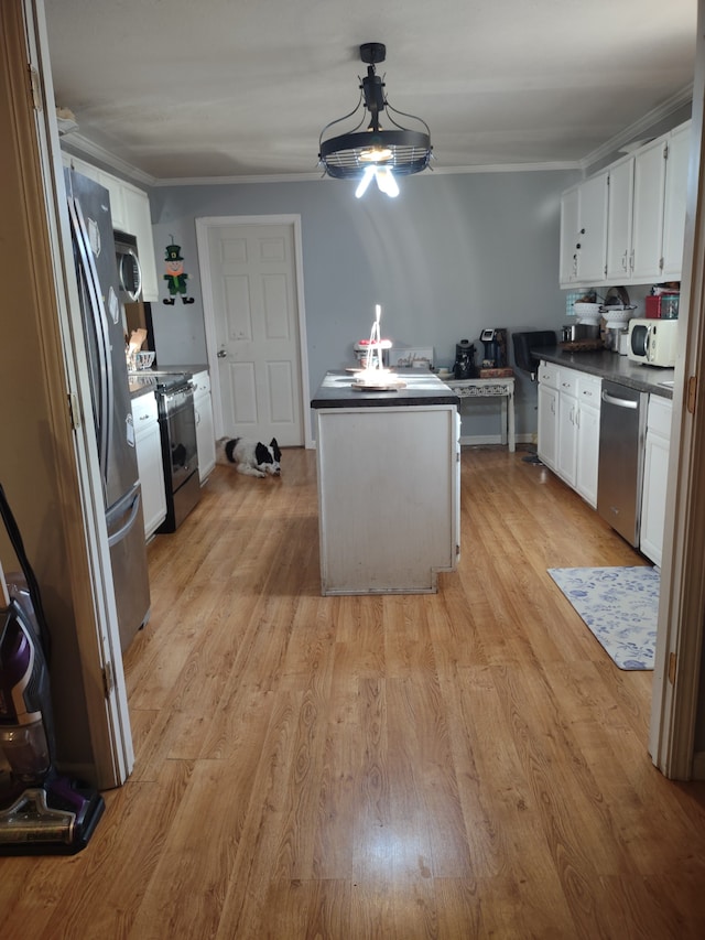 kitchen featuring white cabinets, light wood-type flooring, and stainless steel appliances