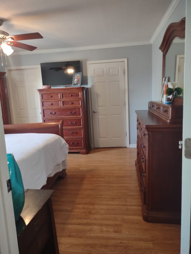 bedroom with wood-type flooring, ceiling fan, and crown molding