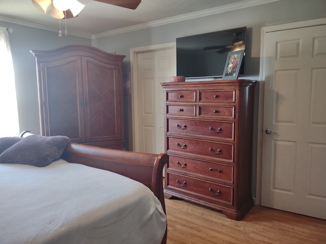 bedroom featuring ornamental molding, ceiling fan, and light wood-type flooring