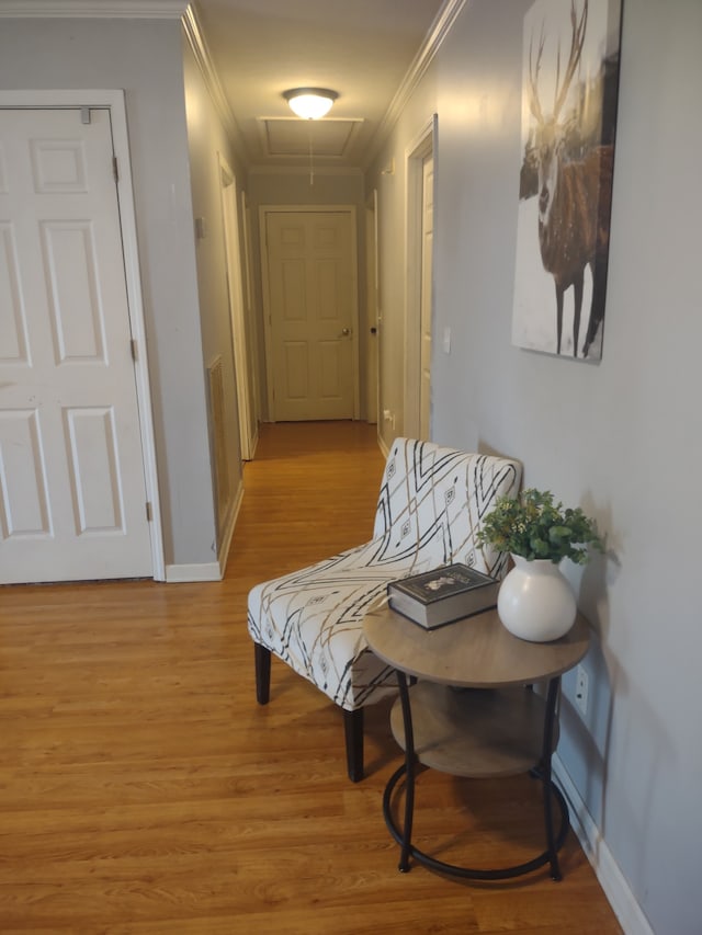 hallway featuring crown molding and light hardwood / wood-style floors