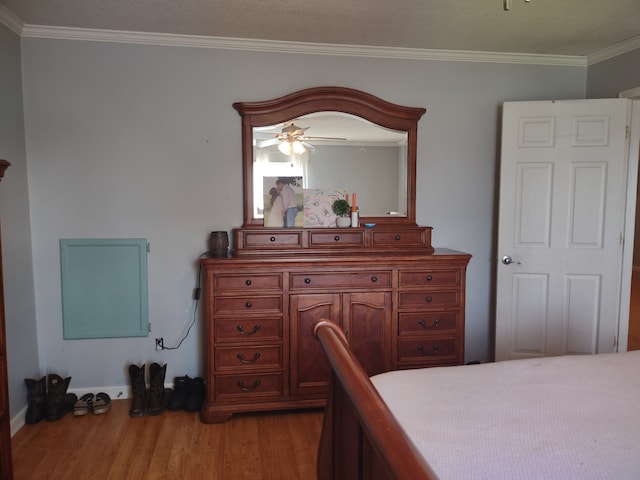 bedroom featuring hardwood / wood-style flooring and ornamental molding