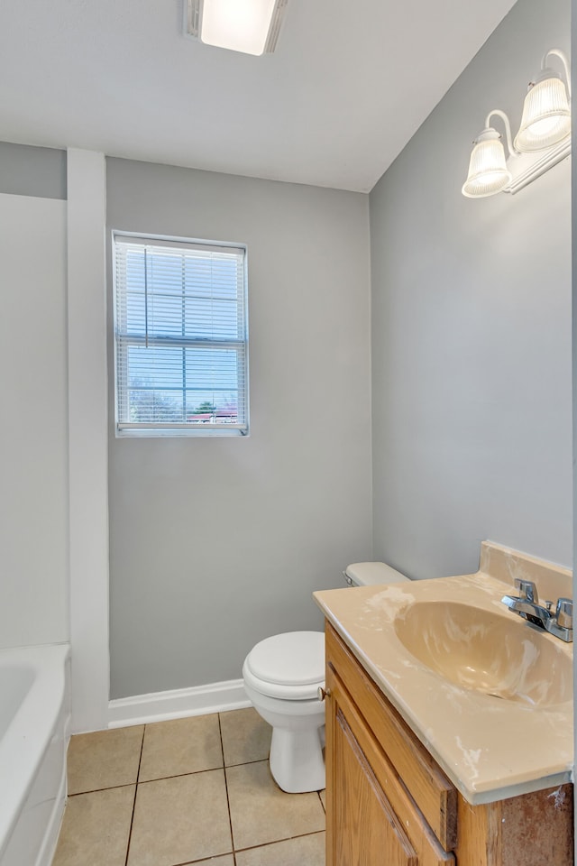 bathroom with vanity, tile floors, and toilet