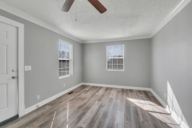 unfurnished room featuring ceiling fan, a textured ceiling, light hardwood / wood-style flooring, and a wealth of natural light