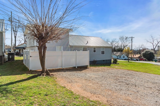 exterior space with a yard and central AC