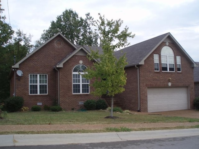 view of front facade featuring a front yard and a garage