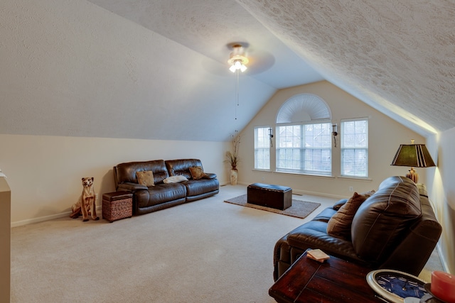 living room with ceiling fan, a textured ceiling, carpet flooring, and vaulted ceiling