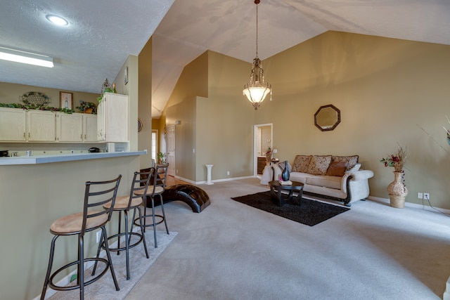 living room featuring lofted ceiling, light carpet, and a textured ceiling