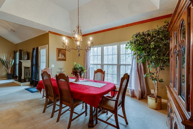 carpeted dining room with high vaulted ceiling and a chandelier