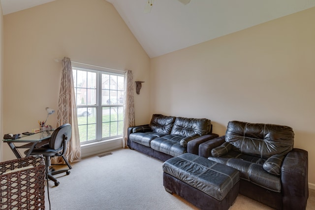 living room with high vaulted ceiling, ceiling fan, and light colored carpet