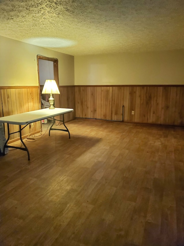 sitting room featuring wood-type flooring and a textured ceiling