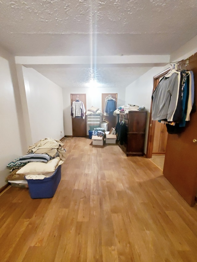 misc room featuring a textured ceiling and light hardwood / wood-style flooring