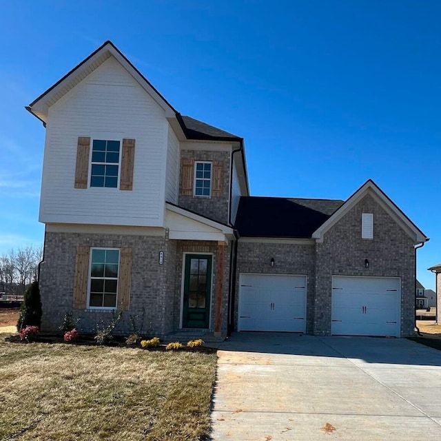 view of front of house with a garage and a front lawn