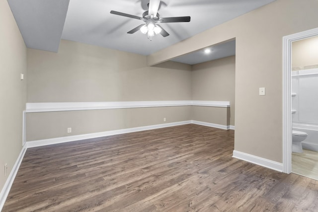 unfurnished room featuring dark hardwood / wood-style flooring and ceiling fan