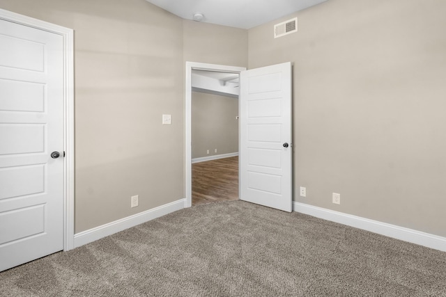 unfurnished bedroom with a closet and carpet floors