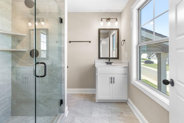 bathroom with an enclosed shower, vanity, and a wealth of natural light