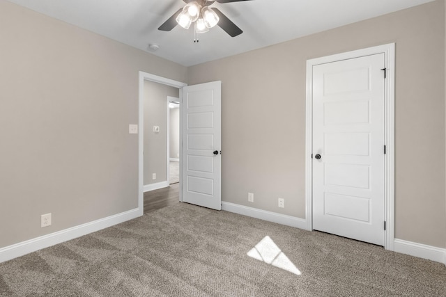 unfurnished bedroom with ceiling fan and carpet floors