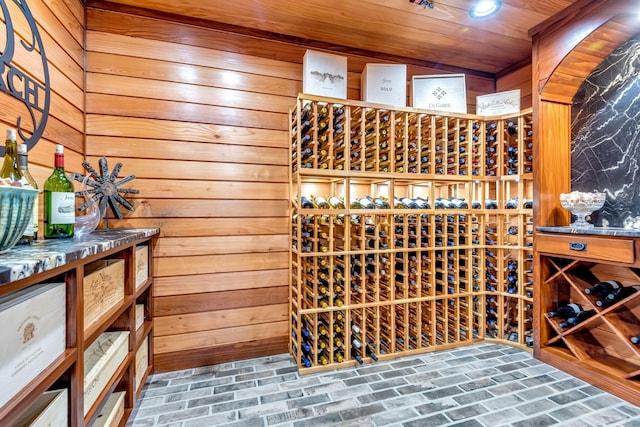 wine area featuring wooden walls and wooden ceiling