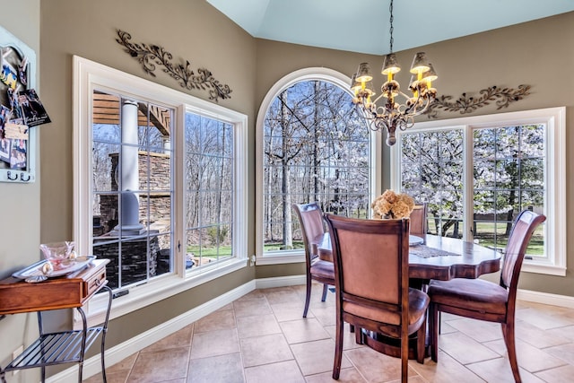 dining area with light tile patterned floors and an inviting chandelier