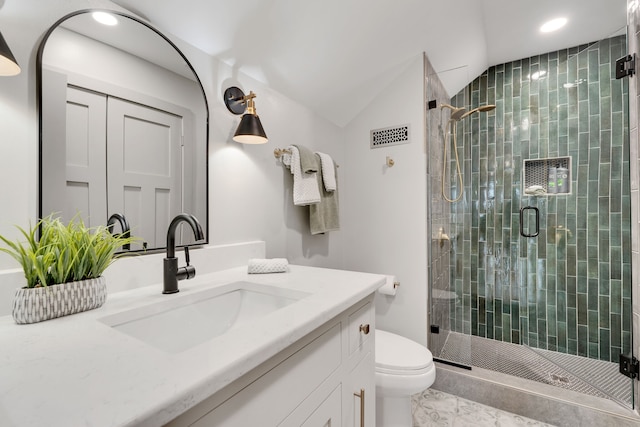 bathroom with lofted ceiling, vanity, toilet, and walk in shower