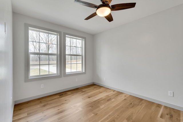 empty room with light hardwood / wood-style flooring and ceiling fan