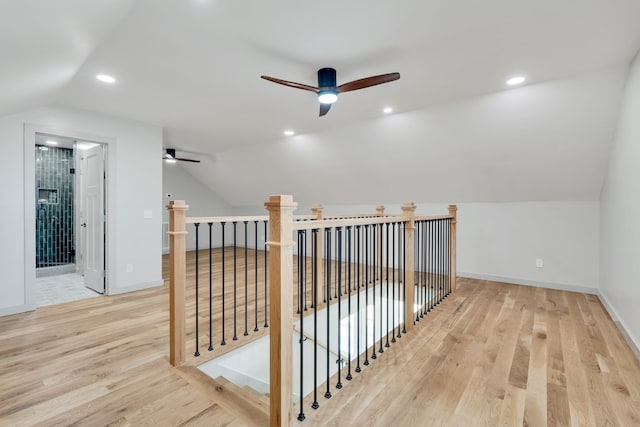 additional living space featuring vaulted ceiling, ceiling fan, and light hardwood / wood-style flooring